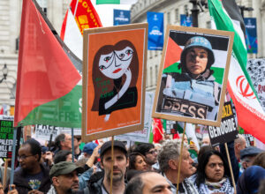 London, UK. 18 May 2024: Protesters hold placards at the Nakba 76 March for Palestine against Israeli attacks on Gaza in central London, UK. — Photo by AndySoloman